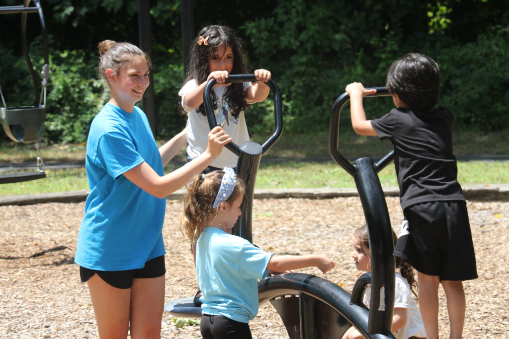 Young children play at the park during the day’s celebration, which included music and Halal food. (Photos by Mike Walsh)